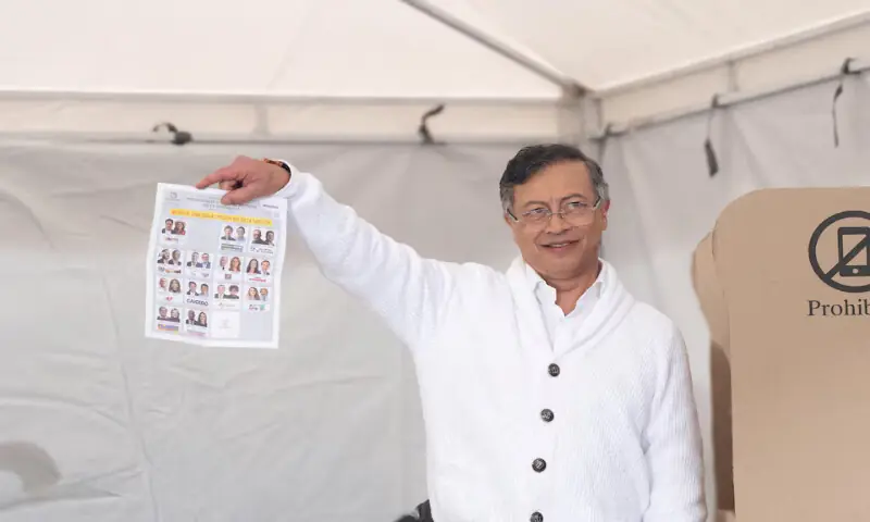 Colombian President Gustavo Petro shows the media his ballot before casting his vote during the first round of the presidential election in Bogota. -- Reuters