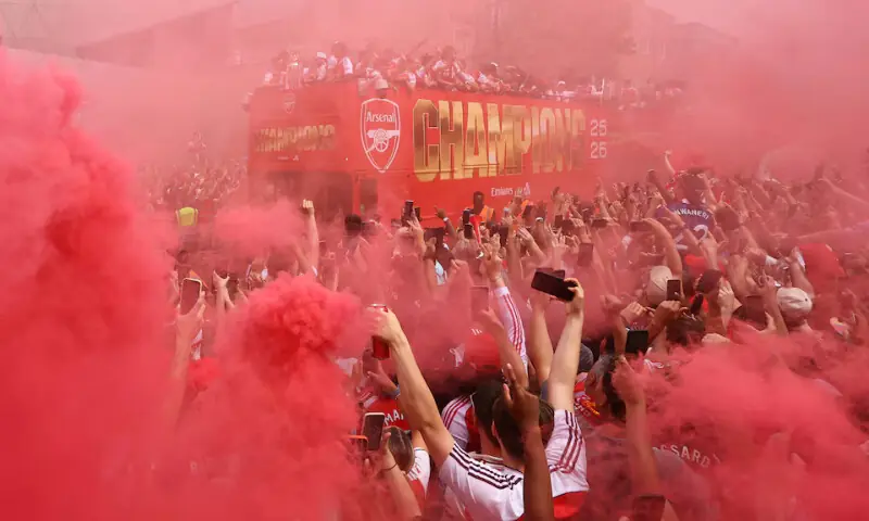 A general view as Arsenal players and fans celebrate during the victory parade in London. -- Reuters