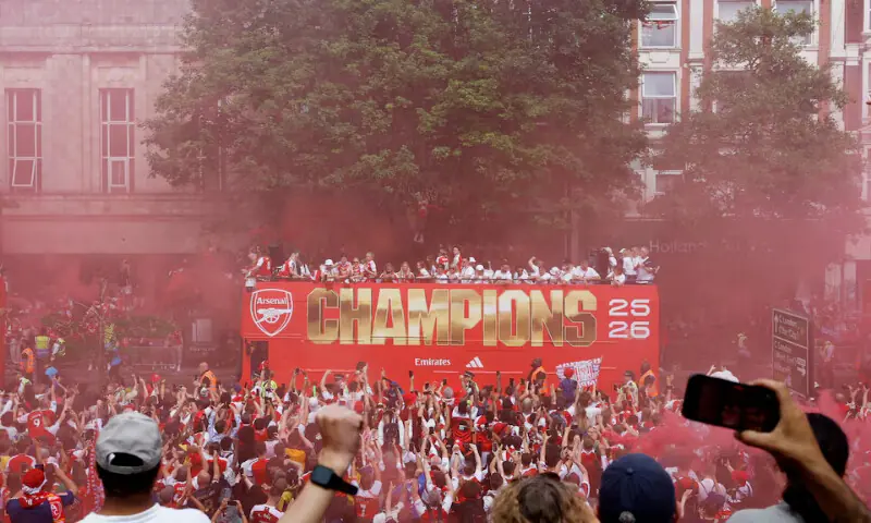 A general view as Arsenal players and fans celebrate during the victory parade in London. -- Reuters