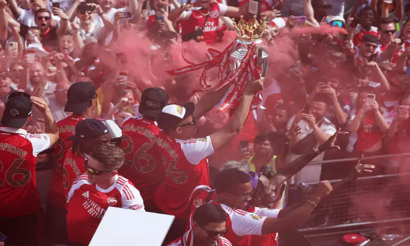 Arsenal's William Saliba and teammates celebrate with the Premier League trophy during the victory parade in London. -- Reuters