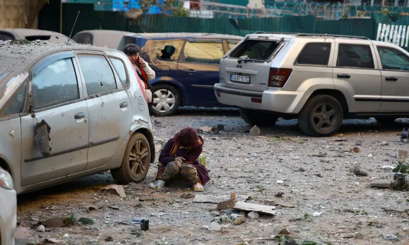 A child sits at the site of Russian missile and drone strikes in Kyiv, Ukraine, on Tuesday. -- Reuters