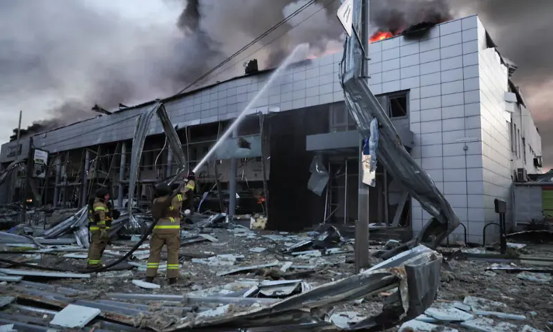 Firefighters work at a car dealership damaged during Russian missile and drone strikes in Kyiv, Ukraine. on Tuesday. -- Reuters