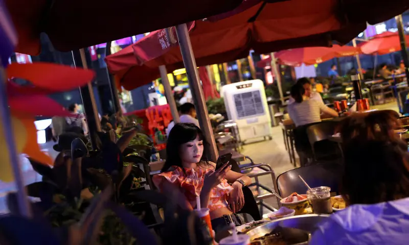 Customers dine at a restaurant in a shopping area of Beijing, China. -- Reuters file