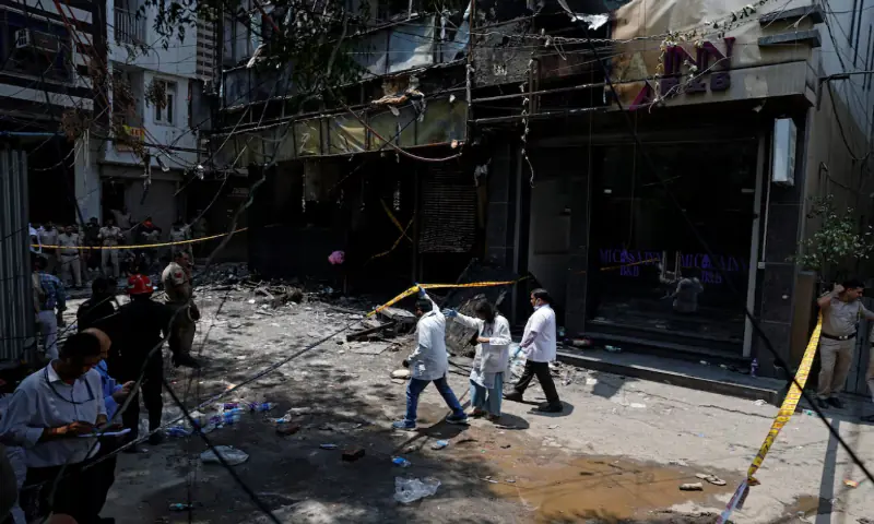 A medical team arrives at the site after a fire at a hotel in New Delhi, India. -- Reuters