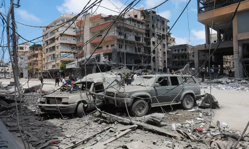 People gather at the site of an Israeli strike in Tyre, Lebanon.-- Reuters