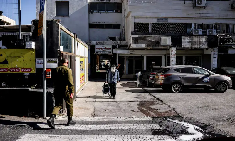 An Israeli soldier crosses a road in Kiryat Shmona, northern Israel. -- Reuters