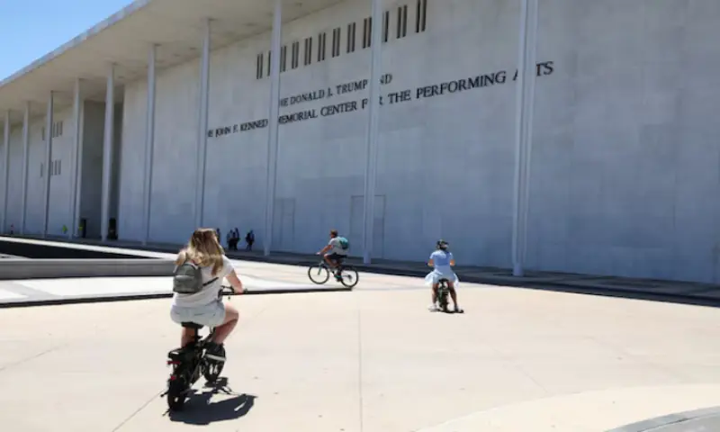 Cyclists ride by the John F. Kennedy Memorial Centre for the Performing Arts, renamed The Donald J. Trump and The John F. Kennedy Memorial Centre for the Performing Arts by the Trump administration, after a federal judge ordered that President Trump&rsquo;s name be removed from the building, in Washington, DC, US. -- Reuters