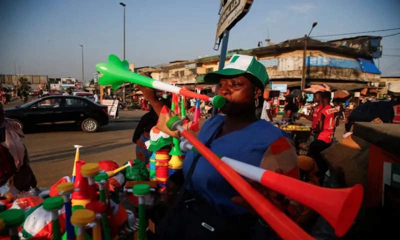 A vendor plays Vuvuzelas while people in Abidjan are getting excited as Ivory Coast gears up to host the Africa Cup of Nations, which begins on Saturday in Abidjan, Ivory Coast. -- Reuters