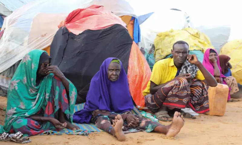Internally displaced people sit outside their makeshift shelters in Kahda district of Mogadishu, Somalia. -- Reuters