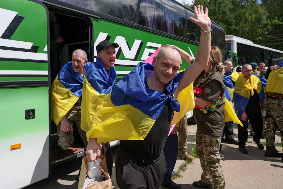Ukrainian prisoners of war (POWs) exit a bus after a swap, amid Russia's attack on Ukraine, at an undisclosed location in Ukraine. -- Reuters