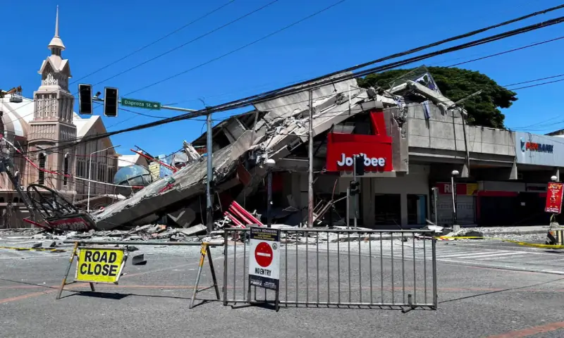 A road is blocked near the collapsed building after a magnitude 7.8 quake in General Santos, Philippines. -- Reuters