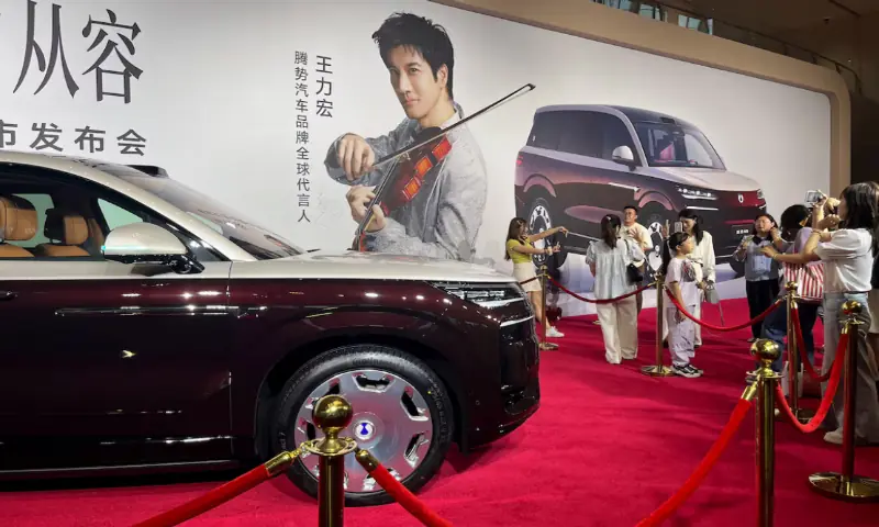 People stand near the newly launched N9 electric vehicle (EV) under BYD's premium brand Denza, displayed at a launch event in Guangzhou, Guangdong province, China. -- Reuters