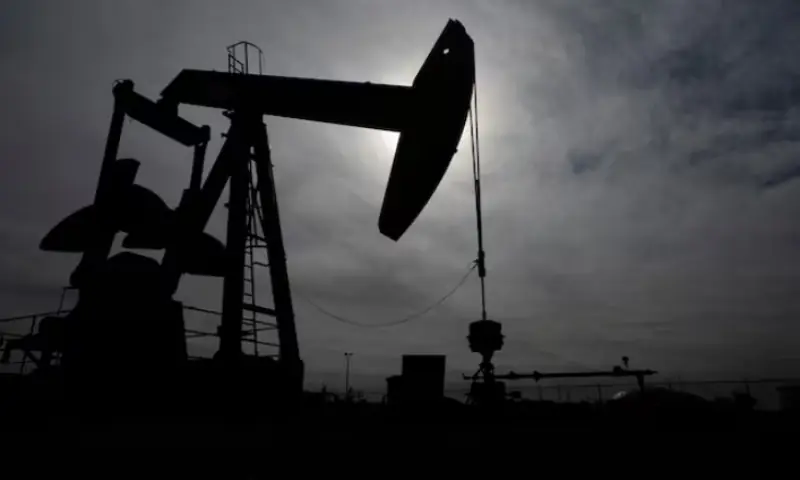 A pump jack operates near a crude oil reserve in the Permian Basin oil field near Midland, Texas, US. -- Reuters