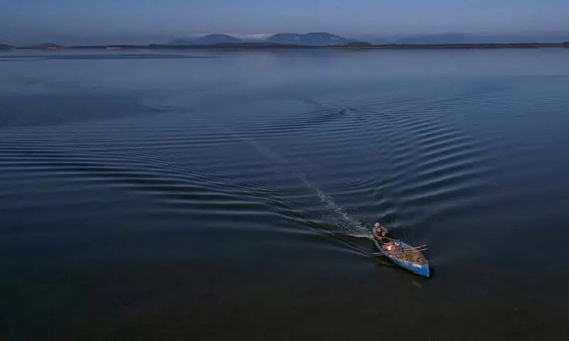 A drone view shows a fisherman sailing his boat near the Vjosa-Narta Protected Area, where a luxury resort is planned by a company linked to Donald Trump's son-in-law, Jared Kushner, in Zvernec near Vlora, Albania. -- Reuters