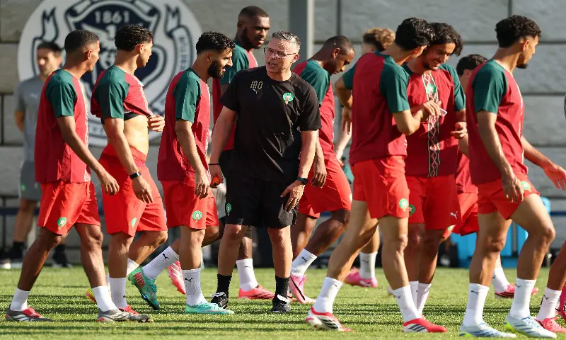 Morocco's head coach Mohamed Ouahbi (centre) speaks with players during a training session at The Pingry School in Basking Ridge, New Jersey on June 12, 2026, on the eve of the 2026 World Cup football match between Brazil and Morocco. AFP