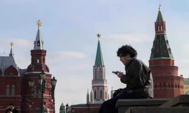 A man checks his mobile phone in central Moscow, Russia. -- Reuters