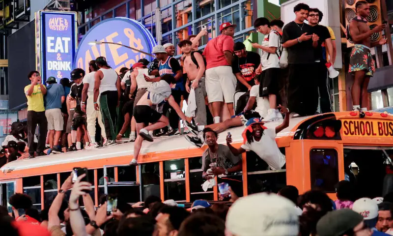 Fans celebrate the New York Knicks' win against the San Antonio Spurs in the NBA Finals at Times Square in New York City, US. -- Reuters