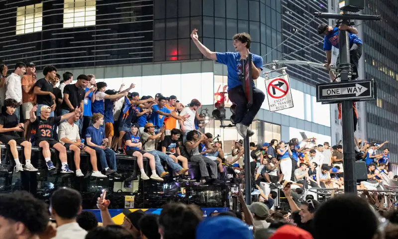 Fans celebrate the New York Knicks' win against the San Antonio Spurs in Game 5 of the NBA Finals, on a street near Madison Square Garden, in New York City, US. -- Reuters
