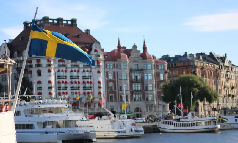A Swedish flag flutters in front of residential houses in Stockholm, Sweden. -- Reuters