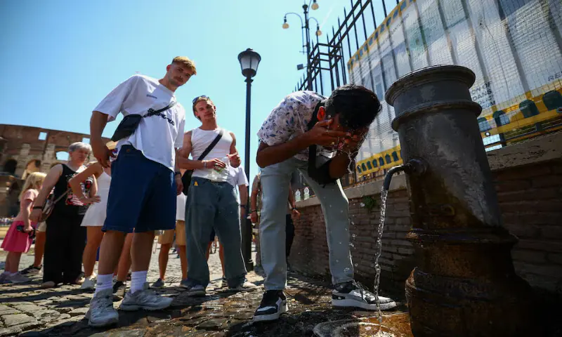 A person cools off from a public fountain near the Colosseum during a heatwave in Rome, Italy. -- Reuters