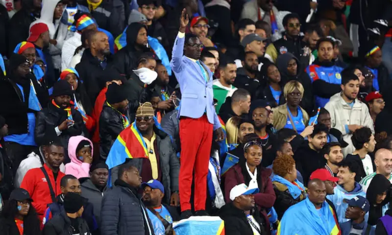 Democratic Republic of Congo fan Michel Nkuka Mboladinga poses as a statue of the country's independence hero Patrice Lumumba during the match. -- Reuters