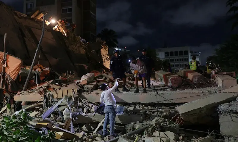 Emergency services at a collapsed building in Caracas. -- Reuters
