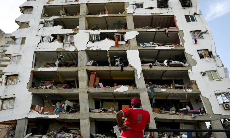 A man looks at a damaged building in the aftermath of earthquakes in La Guaira, Venezuela. -- Reuters