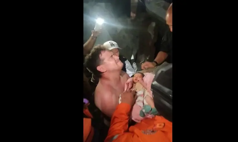 A screengrab taken from a video posted on Instagram on June 26, 2026 shows a newborn baby being pulled out alive from the rubble of the city of La Guaira, Venezuela, after twin earthquakes hit the country. AFP