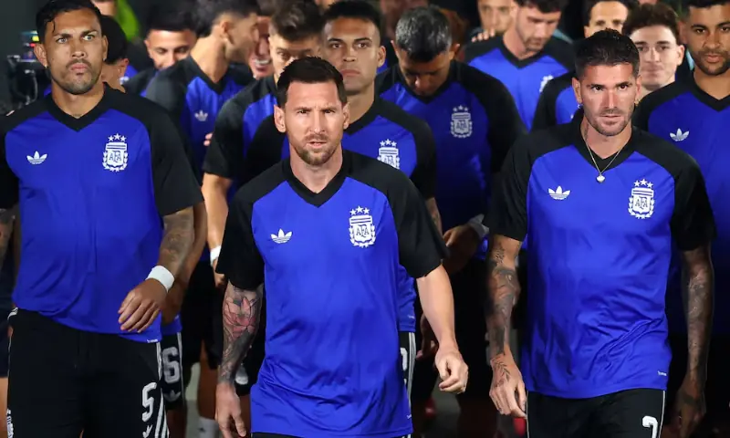 Argentina's Lionel Messi leads his team out for the warm up before the match. -- Reuters