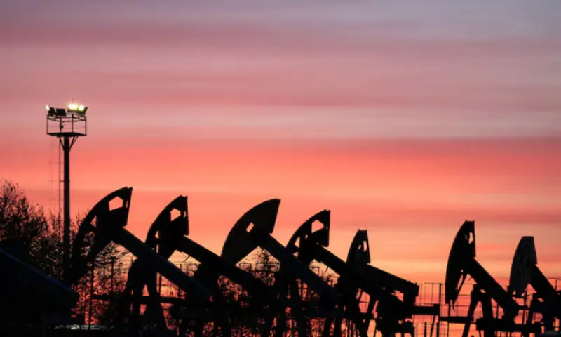 Sunset clouds glow over pump jacks at the Airankol oil field operated by Caspiy Neft in the Atyrau region, Kazakhstan. -- Reuters