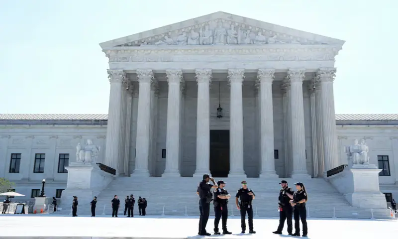 Police officers stand in front of the Supreme Court building on the day the court is set to issue the final rulings of its nine-month term, in Washington, DC, US. -- Reuters
