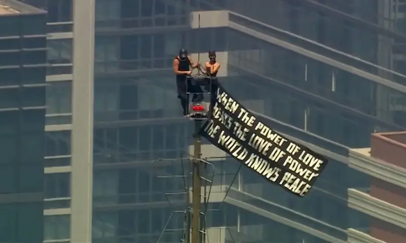 Two people display a banner atop the Empire State Building in the Manhattan borough of New York, US. -- Reuters Two people display a banner atop the Empire State Building in the Manhattan borough of New York, US. -- Reuters