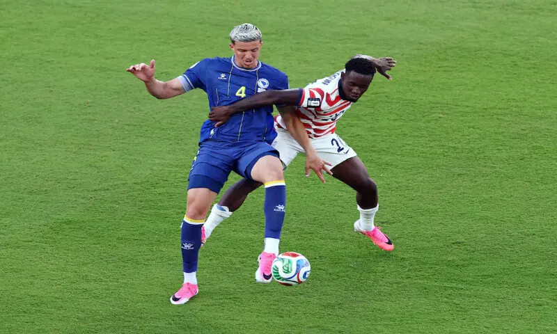 Folarin Balogun of the US fouls Bosnia and Herzegovina's Tarik Muharemovic before being shown a red card. -- Reuters