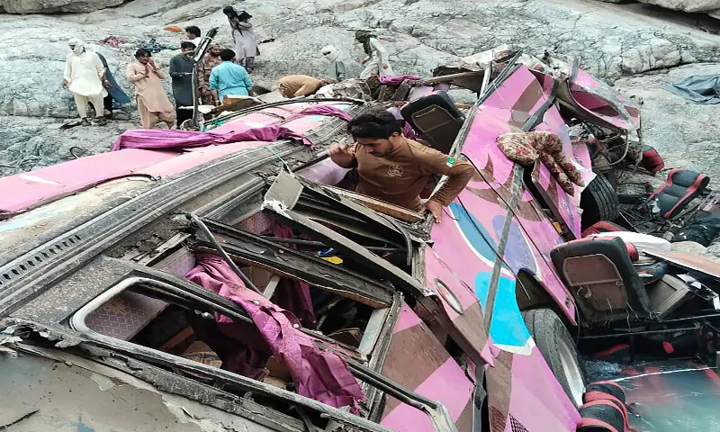 This handout photograph released by Balochistan Emergency Rescue 1122 service on July 3, 2026 shows locals at the crash site of a passenger bus in the mountainous Dana Sar area of Zhob district. AFP