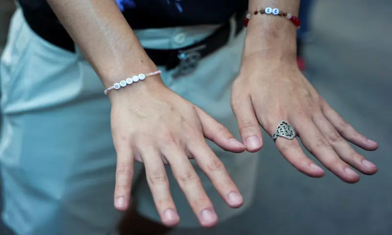 A Taylor Swift fan wears friendship bracelets outside of Madison Square Garden, the venue for the wedding celebrations of singer Taylor Swift and National Football League player Travis Kelce, in New York, US. -- Reuters A Taylor Swift fan wears friendship bracelets outside of Madison Square Garden, the venue for the wedding celebrations of singer Taylor Swift and National Football League player Travis Kelce, in New York, US. -- Reuters