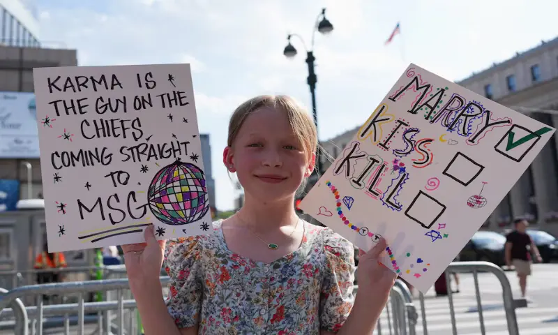 A child holds placards near Madison Square Garden in New York, US. -- Reuters A child holds placards near Madison Square Garden in New York, US. -- Reuters