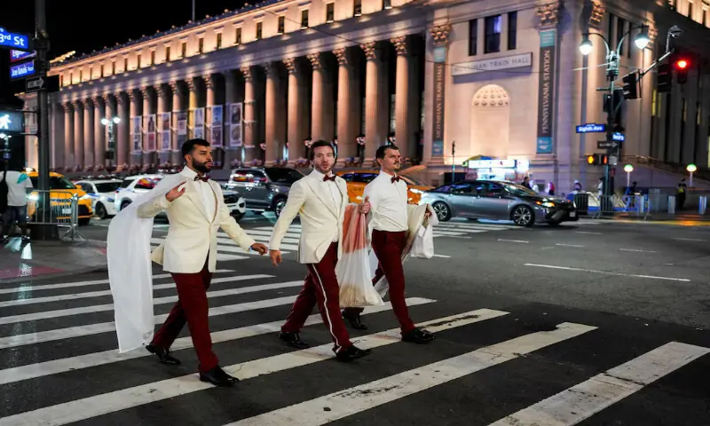 Workers believed to be a part of the wedding between singer Taylor Swift and National Football League player Travis Kelce, cross a road outside Madison Square Garden, in New York City, US. -- Reuters Workers believed to be a part of the wedding between singer Taylor Swift and National Football League player Travis Kelce, cross a road outside Madison Square Garden, in New York City, US. -- Reuters