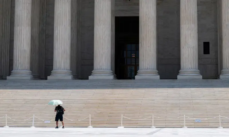 A person uses an umbrella to block the sun at the Supreme Court amid a heatwave in Washington, DC. -- Reuters A person uses an umbrella to block the sun at the Supreme Court amid a heatwave in Washington, DC. -- Reuters