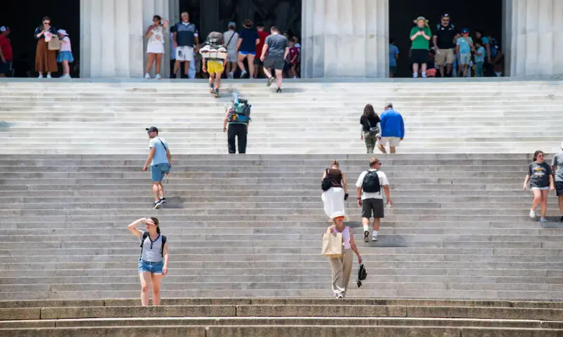 A person descending the stairs of the Lincoln Memorial covers her face with her hand amid a heatwave in Washington, DC. -- Reuters A person descending the stairs of the Lincoln Memorial covers her face with her hand amid a heatwave in Washington, DC. -- Reuters