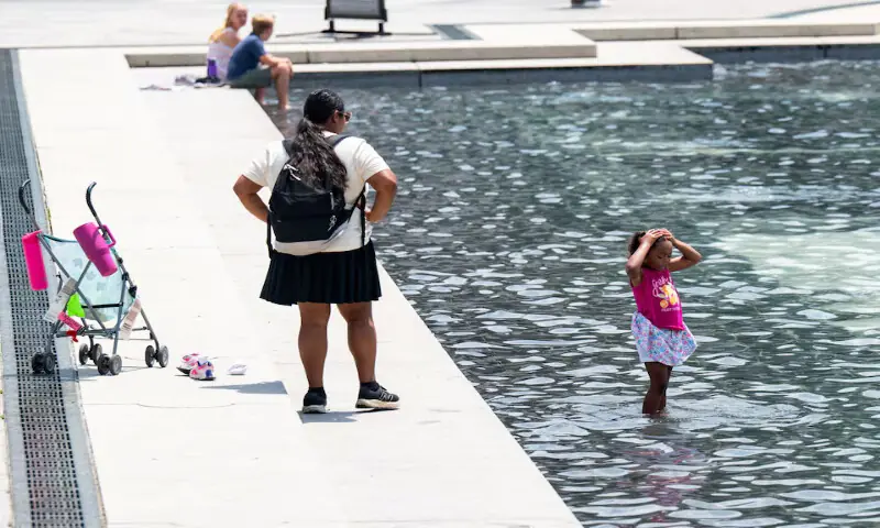 A girl splashes water onto herself at the World War II Memorial amid a heatwave in Washington, DC. -- Reuters A girl splashes water onto herself at the World War II Memorial amid a heatwave in Washington, DC. -- Reuters