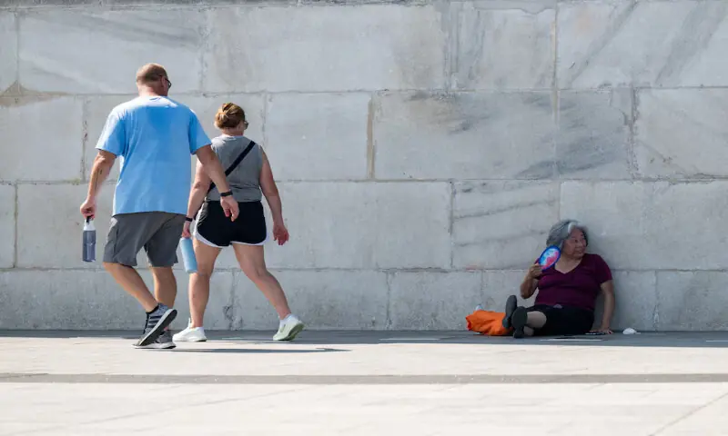 A woman sits in the shade and fans herself at the base of the Washington Monument due to excessive heat in Washington, DC. -- Reuters A woman sits in the shade and fans herself at the base of the Washington Monument due to excessive heat in Washington, DC. -- Reuters