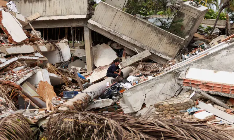 A man pauses while searching for his family members beneath the rubble in Los Corales, La Guaira, Venezuela. -- Reuters