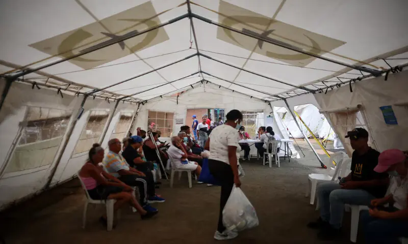 People sit at a field hospital in the aftermath of the June 24 earthquakes, in La Guaira, Venezuela. -- Reuters