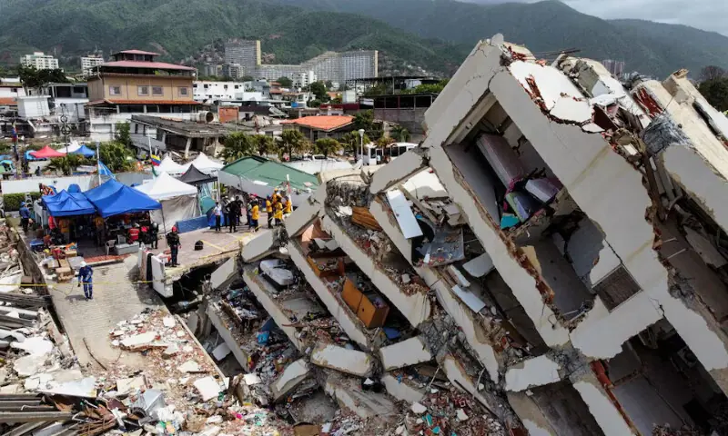 A drone view shows rescuers working at the site of collapsed buildings in the aftermath of the June 24 earthquakes in Los Corales, La Guaira, Venezuela. -- Reuters
