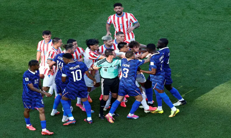 France's Ousmane Dembele clashes with Paraguay players after Andres Cubas fouls Kylian Mbappe. -- Reuters