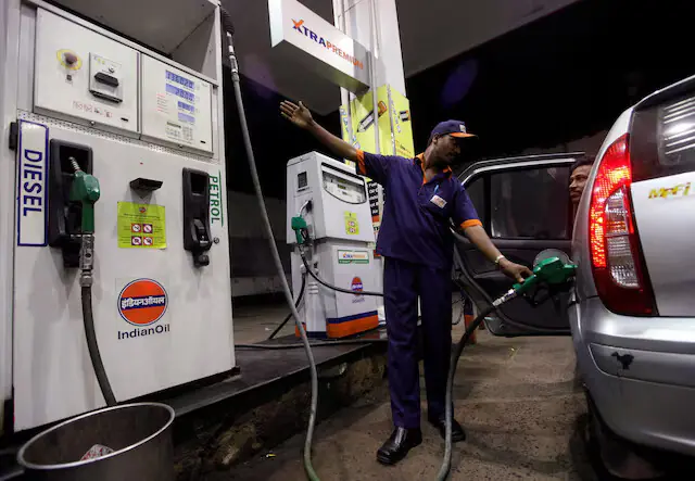 A worker fills a car with petrol as he gestures towards the fuel barometer for the passenger to check, at a fuel station in Kolkata. -- Reuters file A worker fills a car with petrol as he gestures towards the fuel barometer for the passenger to check, at a fuel station in Kolkata. -- Reuters file