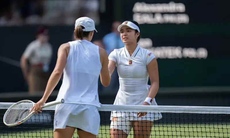 Alexandra Eala of the Philippinesr at the net with Iga Swiatek of Poland after their match on day six at All England Lawn Tennis and Croquet Club. -- Reuters