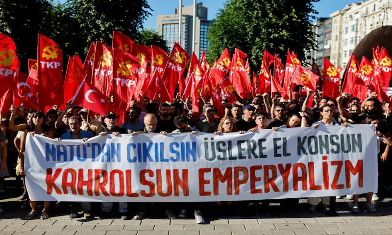 People carry a banner during a protest ahead of NATO leaders' summit in Istanbul, Turkey. -- Reuters People carry a banner during a protest ahead of NATO leaders' summit in Istanbul, Turkey. -- Reuters
