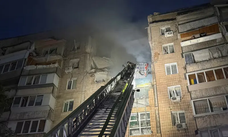 A firefighter works at a site of an apartment building hit during Russian missile and drone strike in Kyiv, Ukraine, on Monday. -- Reuters