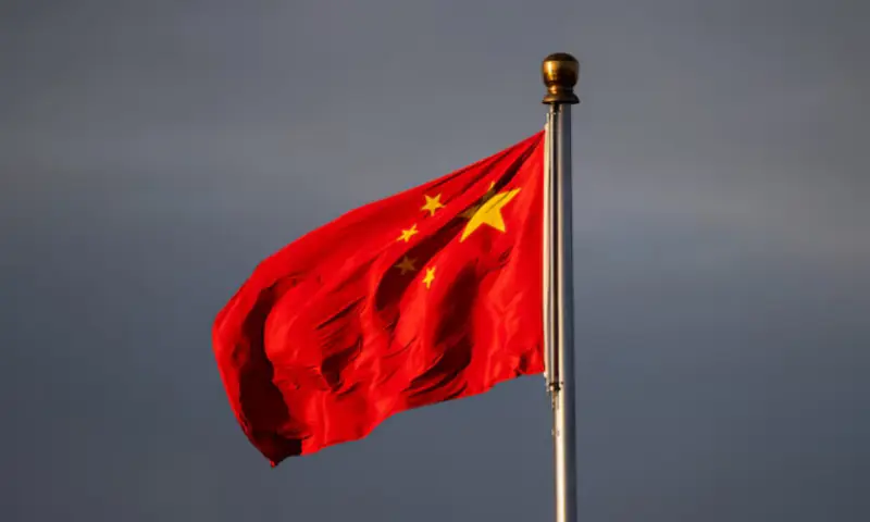 China&rsquo;s national flag flutters in the wind, lit by sunrise in Beijing, China. -- Reuters